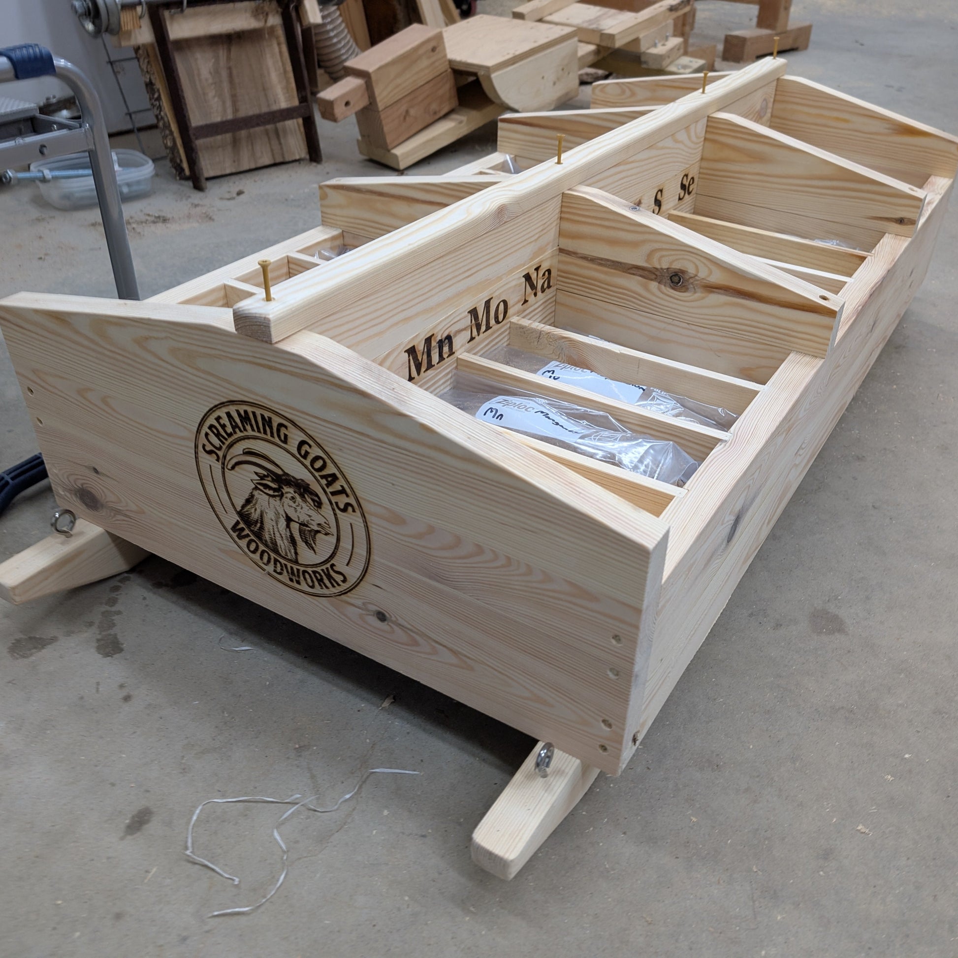 Wooden mineral cart showing the complete wooden structure with bags of loose mineral in each compartment.