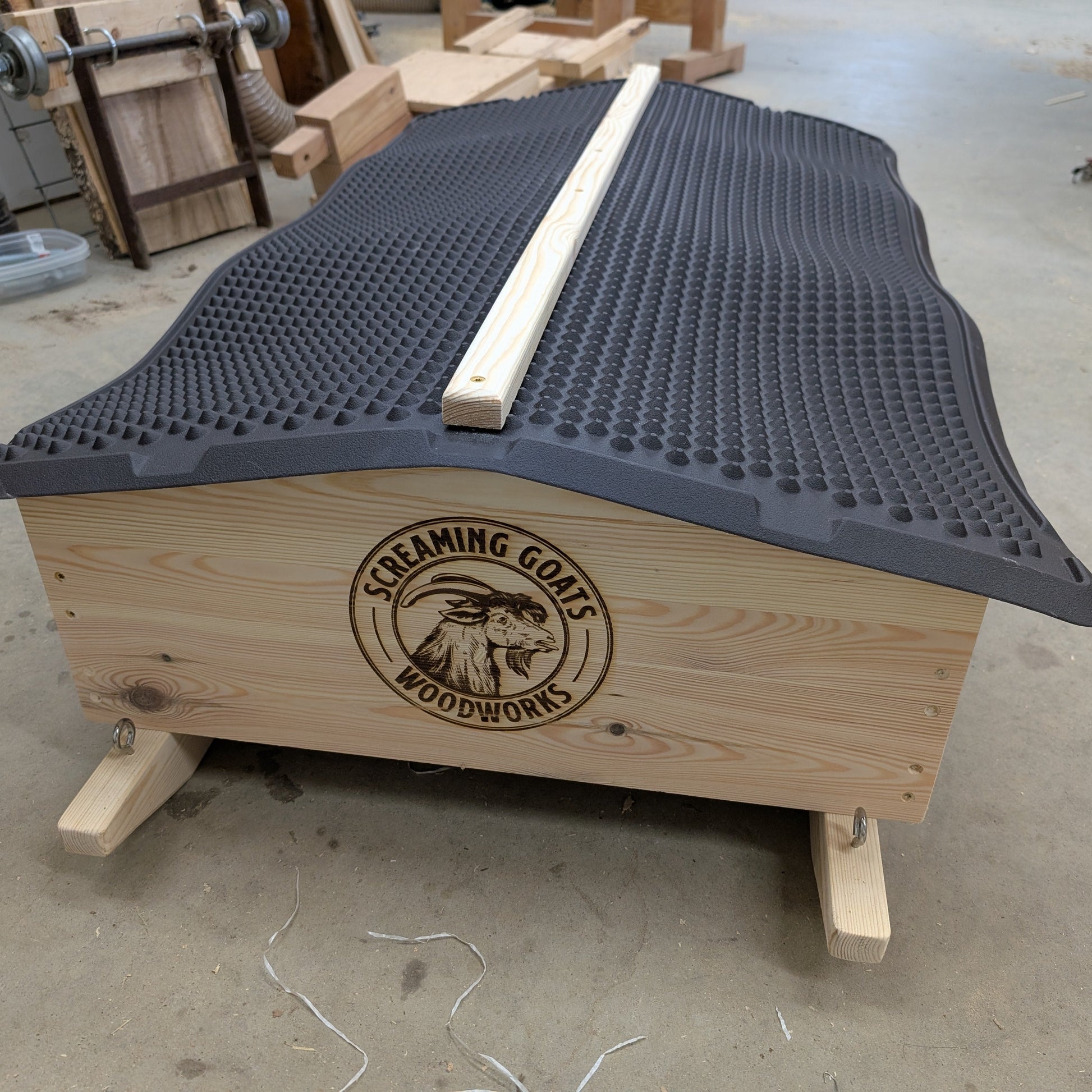 Wooden mineral cart on sleds for rotational grazing. Eyelets can be attached to rope or chain for manual or mechanical towing.